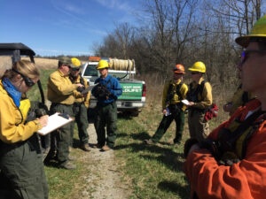 Group gathered for safety briefing before fireburn to restore grasslands.
