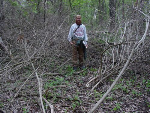 student in invasive forest