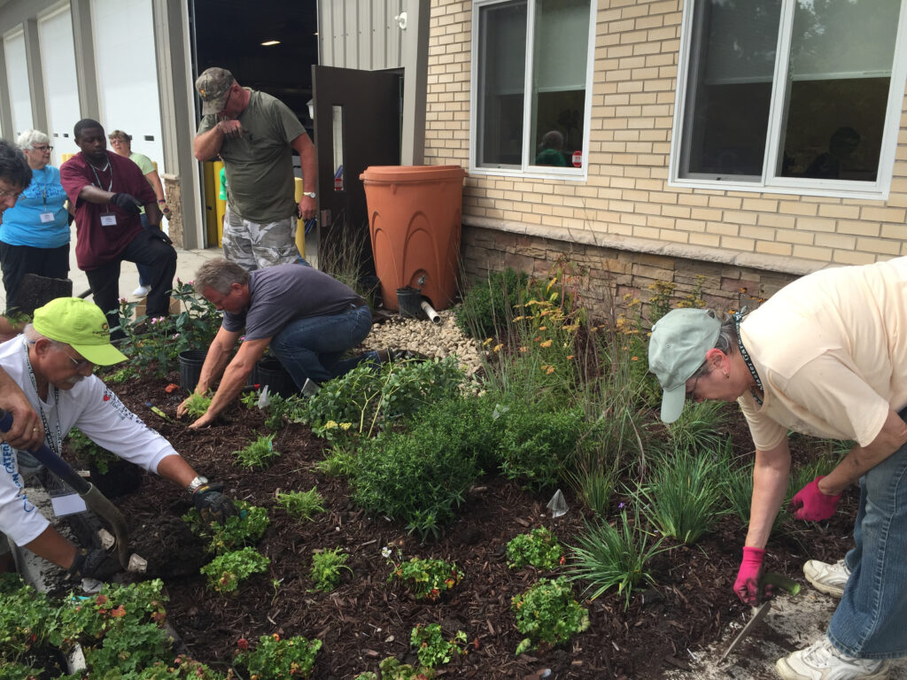 Group of people planting and rainscaping